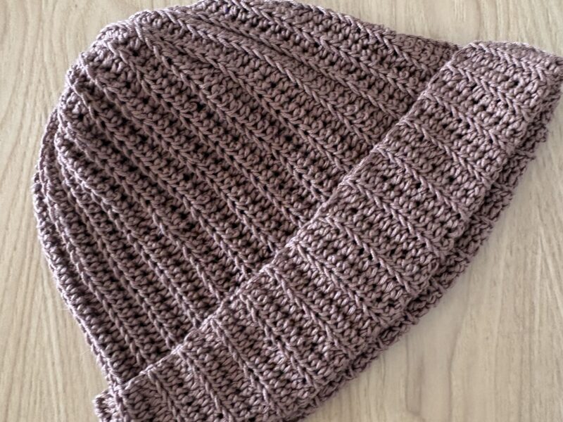 Learn how to crochet an easy ribbed beanie that looks professional and store-bought! This free pattern uses just two basic stitches. Perfect for beginners!
